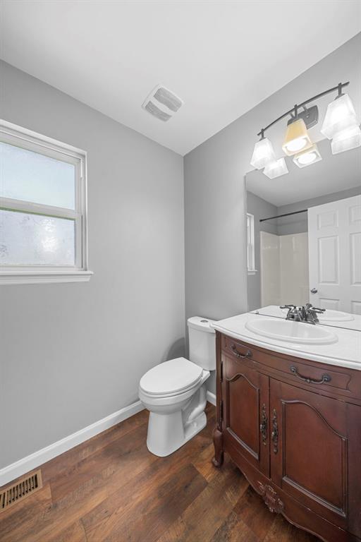 433 Fawn Run Dr, Troy, MO 63379 - bathroom with vanity, wood finished floors, toilet, and baseboards