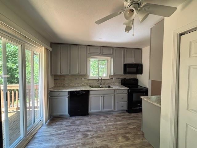 201 Penelope Pl, Olympian Village, MO 63020 - kitchen with black appliances, a sink, gray cabinetry, backsplash, and light countertops