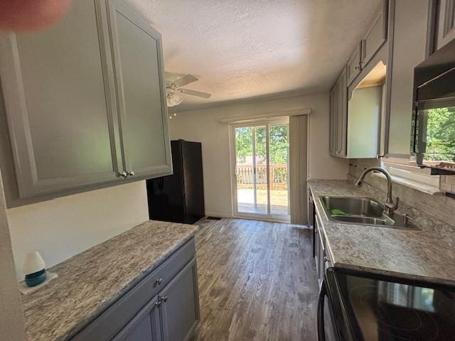 201 Penelope Pl, Olympian Village, MO 63020 - kitchen featuring black appliances, a sink, dark wood-style floors, a textured ceiling, and ceiling fan