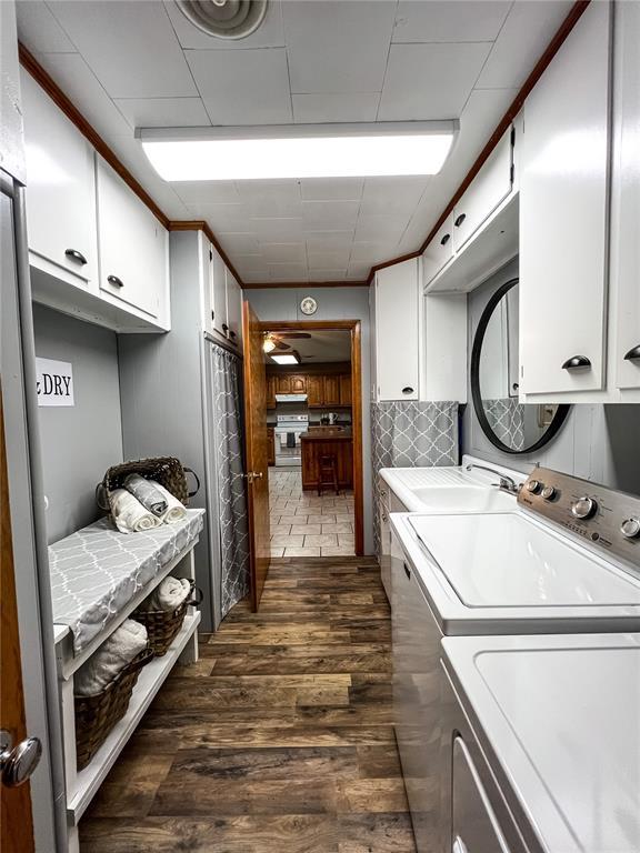 619 Cleveland St, Paris, MO 65275 - washroom featuring cabinet space, washer and clothes dryer, and dark wood-style flooring