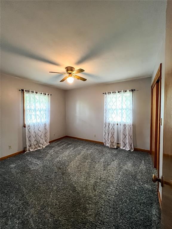 619 Cleveland St, Paris, MO 65275 - carpeted empty room featuring ceiling fan and baseboards