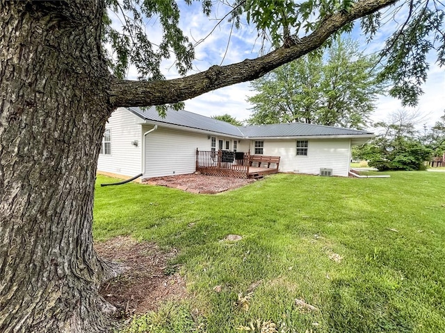 619 Cleveland St, Paris, MO 65275 - rear view of property featuring a deck, a yard, metal roof, and central air condition unit