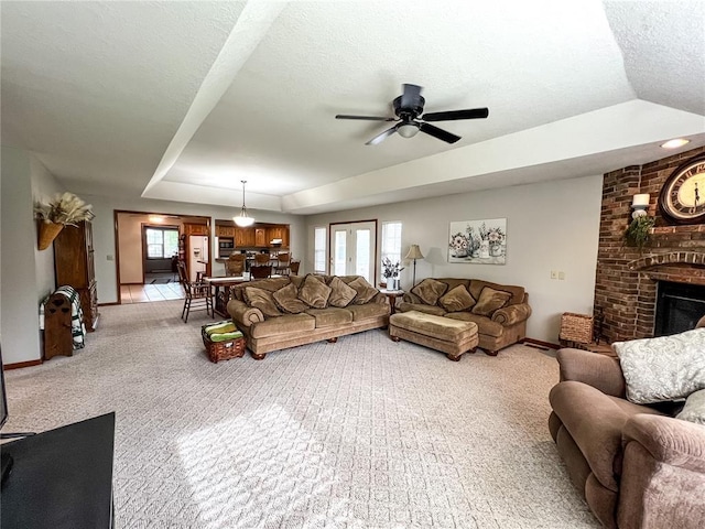 619 Cleveland St, Paris, MO 65275 - living area with carpet, a fireplace, baseboards, a ceiling fan, and a textured ceiling