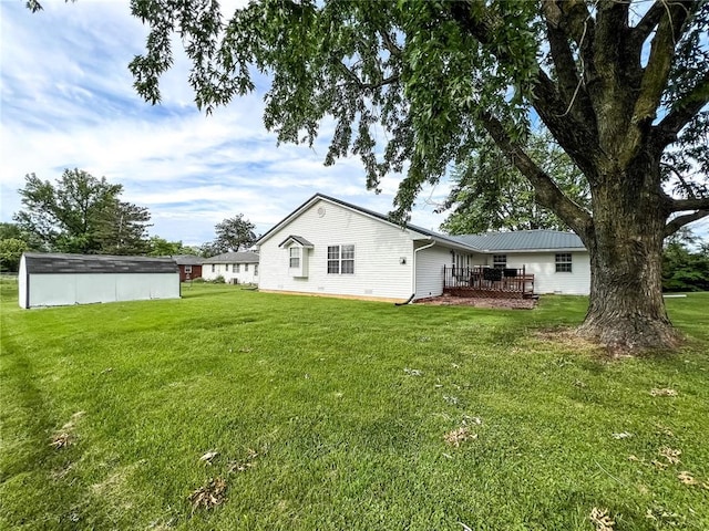 619 Cleveland St, Paris, MO 65275 - back of house featuring a lawn and a wooden deck