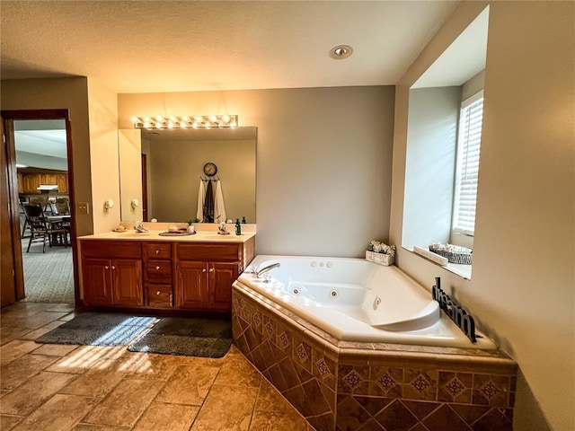 619 Cleveland St, Paris, MO 65275 - bathroom with a jetted tub, double vanity, and stone tile flooring