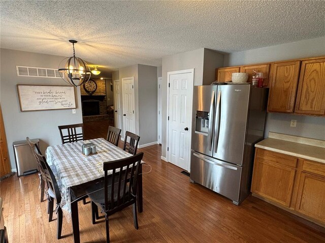 102 Riverview Bend Estates Dr, Crystal City, MO 63019 - dining area with a chandelier, dark wood-type flooring, a textured ceiling, and baseboards