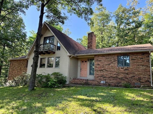 16463 Terrace Dr, Dexter, MO 63841 - view of front of property with a balcony, a chimney, a front lawn, and brick siding