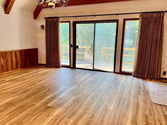 16463 Terrace Dr, Dexter, MO 63841 - spare room featuring beam ceiling, a chandelier, wood finished floors, and a wainscoted wall
