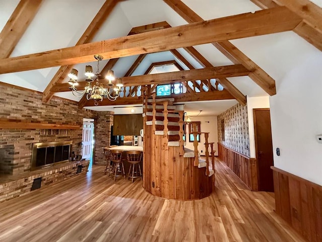 16463 Terrace Dr, Dexter, MO 63841 - living area with wainscoting, a chandelier, beamed ceiling, wood finished floors, and high vaulted ceiling