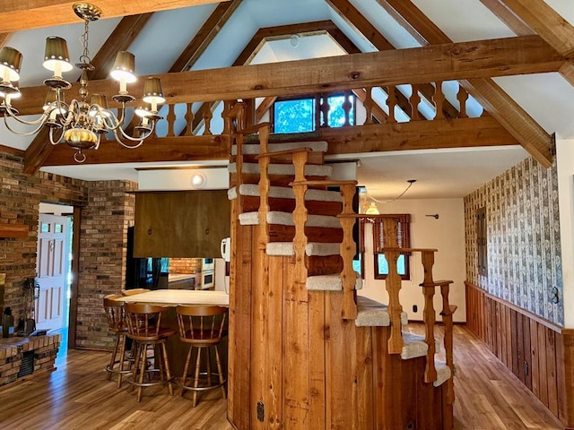 16463 Terrace Dr, Dexter, MO 63841 - dining space with wood finished floors, stairway, a chandelier, and brick wall
