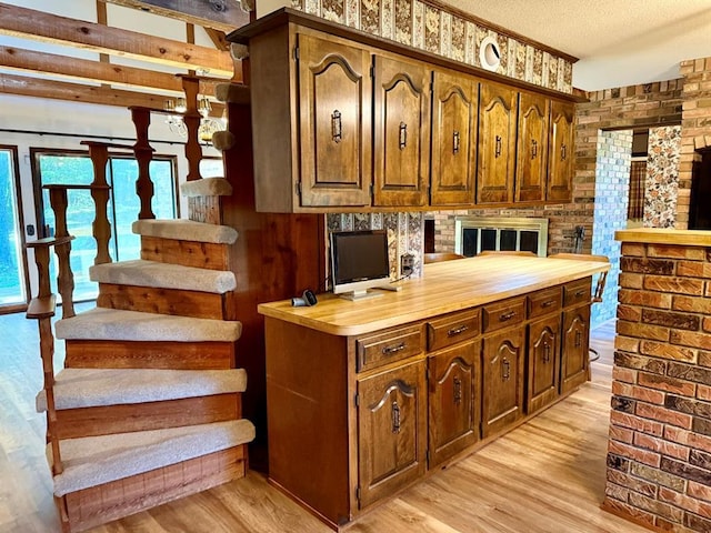 16463 Terrace Dr, Dexter, MO 63841 - kitchen with light wood-style flooring, wood counters, and a textured ceiling