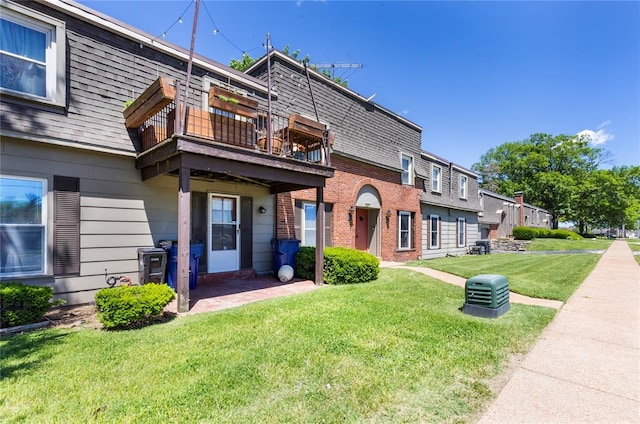 6691 Parker Rd Unit A, Florissant, MO 63033 - view of front of house featuring a front yard, roof with shingles, brick siding, and mansard roof