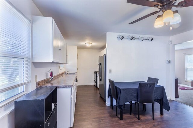 6691 Parker Rd Unit A, Florissant, MO 63033 - kitchen with a sink, freestanding refrigerator, dark wood-type flooring, white cabinetry, and a ceiling fan