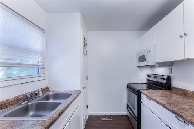 6691 Parker Rd Unit A, Florissant, MO 63033 - kitchen with stainless steel electric range, a sink, white microwave, dark wood-style floors, and white cabinets