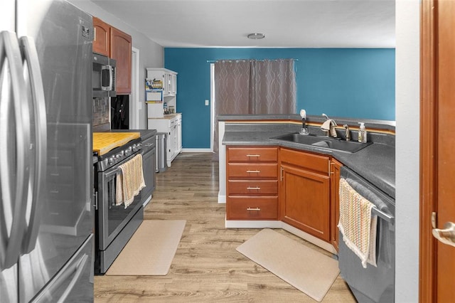 1519 Progress Ln, Belleville, IL 62221 - kitchen featuring stainless steel appliances, a sink, light wood finished floors, and brown cabinets