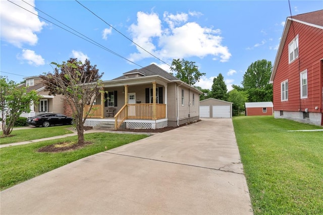 408 W State St, Union, MO 63084 - view of front of home with covered porch, a garage, an outbuilding, and a front yard