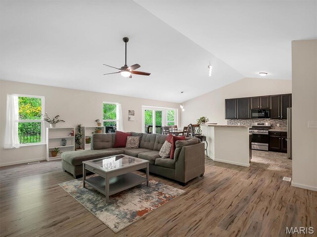 1109 Foxwood Estates Dr, Arnold, MO 63010 - living area featuring lofted ceiling, ceiling fan, light wood-type flooring, and baseboards