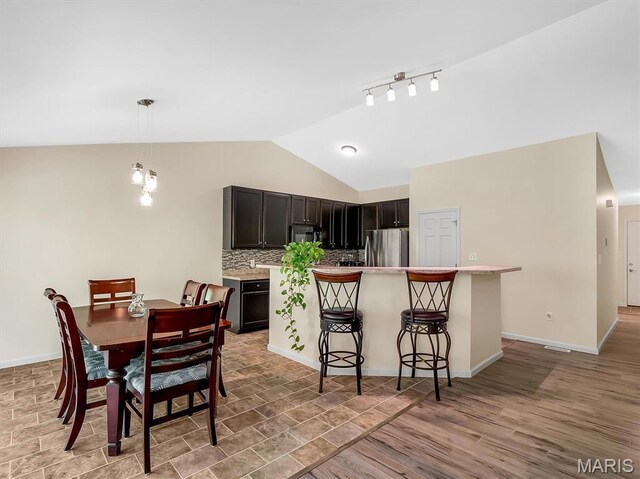 1109 Foxwood Estates Dr, Arnold, MO 63010 - dining area with vaulted ceiling and baseboards