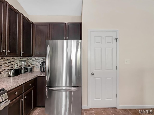 1109 Foxwood Estates Dr, Arnold, MO 63010 - kitchen with appliances with stainless steel finishes, dark brown cabinetry, baseboards, and light countertops