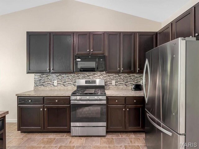 1109 Foxwood Estates Dr, Arnold, MO 63010 - kitchen featuring stainless steel appliances, lofted ceiling, dark brown cabinetry, backsplash, and light countertops