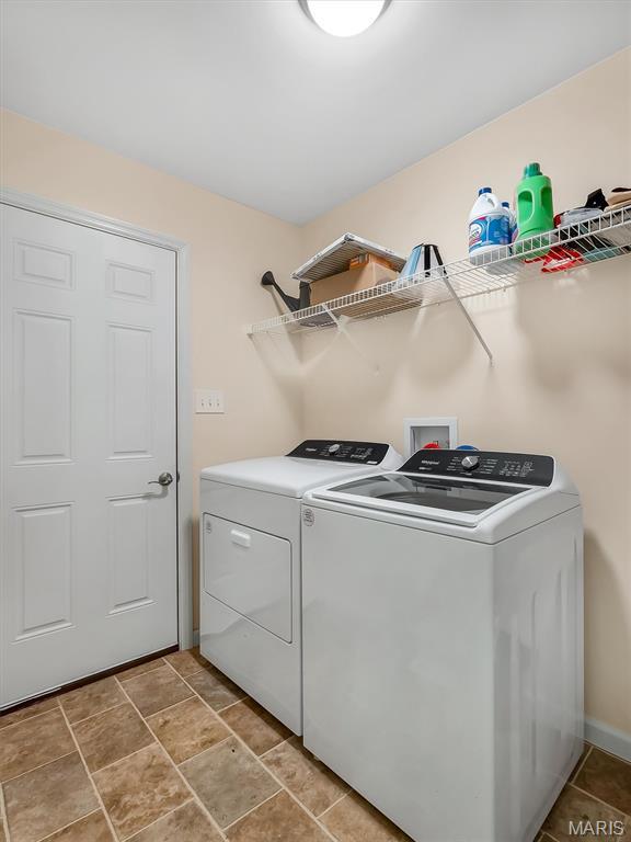 1109 Foxwood Estates Dr, Arnold, MO 63010 - laundry area featuring separate washer and dryer and baseboards