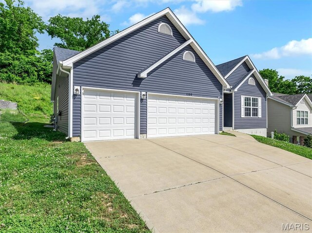 1109 Foxwood Estates Dr, Arnold, MO 63010 - view of front of house featuring driveway, a garage, and a front yard