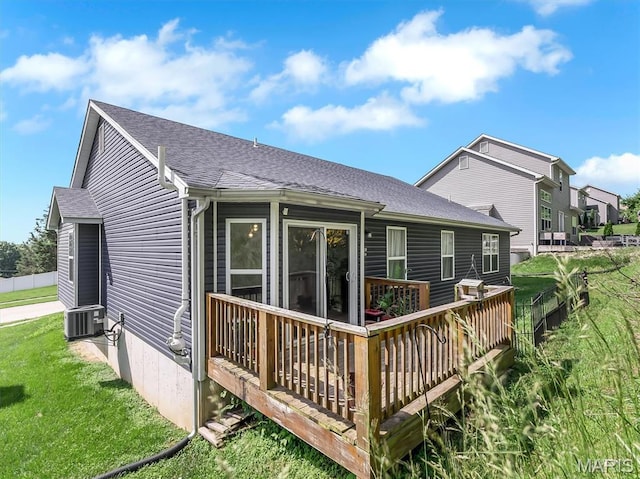 1109 Foxwood Estates Dr, Arnold, MO 63010 - back of house with roof with shingles, a wooden deck, a lawn, and central AC unit