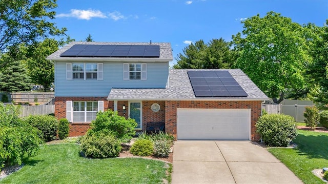 1102 Affirm Dr, Ofallon, IL 62269 - traditional home featuring solar panels, brick siding, a garage, driveway, and a shingled roof