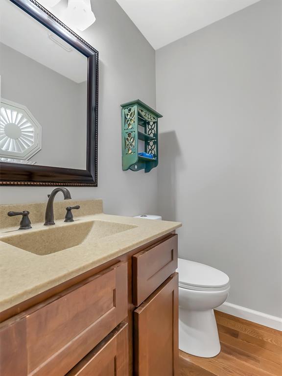 1102 Affirm Dr, Ofallon, IL 62269 - bathroom featuring vanity, toilet, wood finished floors, and baseboards