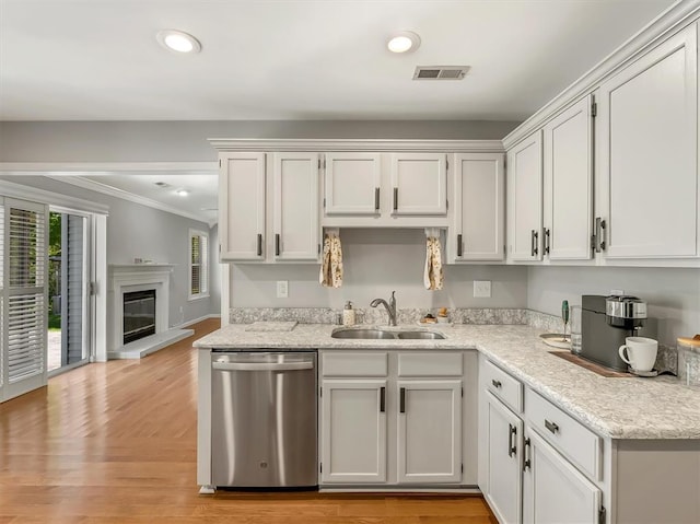 1102 Affirm Dr, Ofallon, IL 62269 - kitchen featuring stainless steel dishwasher, a sink, crown molding, recessed lighting, and a glass covered fireplace