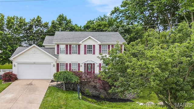 1575 Uthoff Dr, Fenton, MO 63026 - colonial-style house with a garage, driveway, a front lawn, and roof with shingles