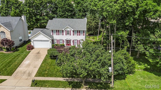 1575 Uthoff Dr, Fenton, MO 63026 - colonial inspired home featuring an attached garage, concrete driveway, and a front yard