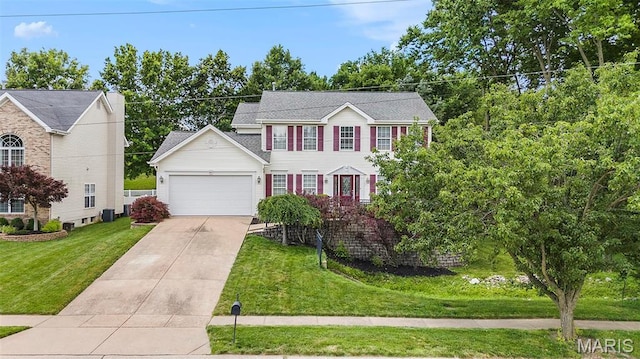 1575 Uthoff Dr, Fenton, MO 63026 - colonial home featuring a garage, driveway, and a front lawn