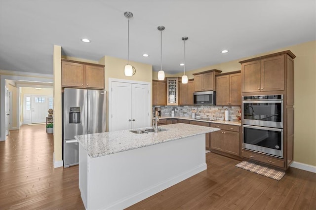 1355 Bloomfield Dr, Eureka, MO 63025 - kitchen featuring stainless steel appliances, brown cabinetry, dark wood finished floors, and recessed lighting