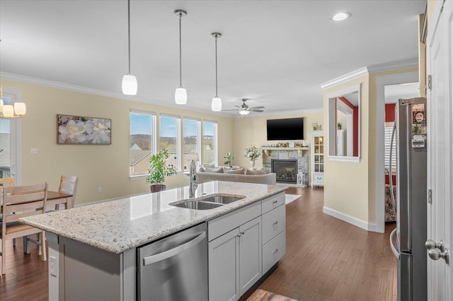 1355 Bloomfield Dr, Eureka, MO 63025 - kitchen featuring stainless steel appliances, a sink, a ceiling fan, a fireplace, and crown molding