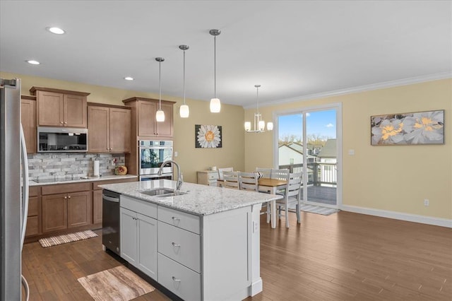 1355 Bloomfield Dr, Eureka, MO 63025 - kitchen with stainless steel appliances, a sink, dark wood finished floors, baseboards, and decorative backsplash