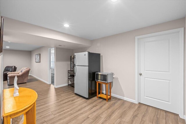 1355 Bloomfield Dr, Eureka, MO 63025 - kitchen with freestanding refrigerator, baseboards, light wood-style flooring, recessed lighting, and stainless steel microwave