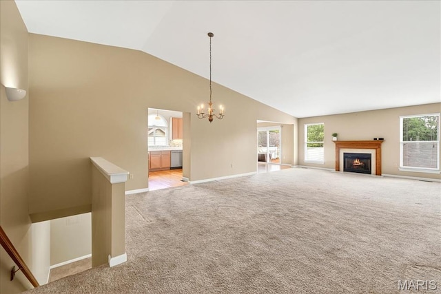 1423 Villas Estates Dr, Saint Louis, MO 63026 - unfurnished living room featuring lofted ceiling, light colored carpet, a chandelier, and a lit fireplace