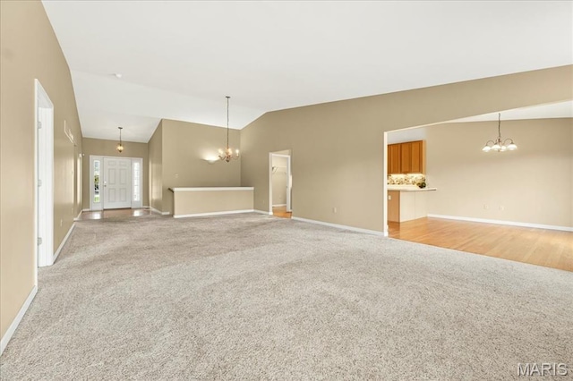 1423 Villas Estates Dr, Saint Louis, MO 63026 - unfurnished living room with light carpet, a chandelier, and vaulted ceiling
