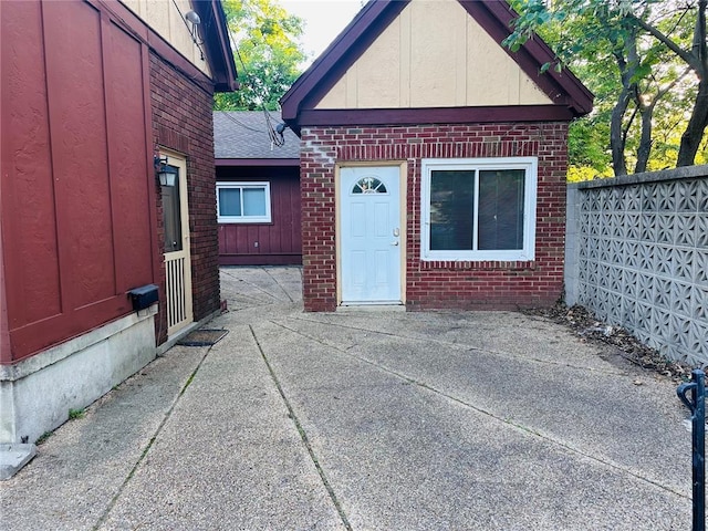 417 S Kingshighway St, Sikeston, MO 63801 - doorway to property featuring brick siding, a patio, and roof with shingles
