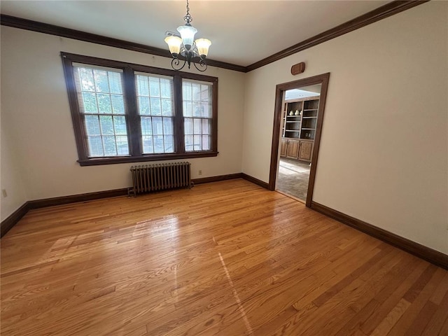 417 S Kingshighway St, Sikeston, MO 63801 - spare room with radiator heating unit, a chandelier, crown molding, light wood-style floors, and baseboards
