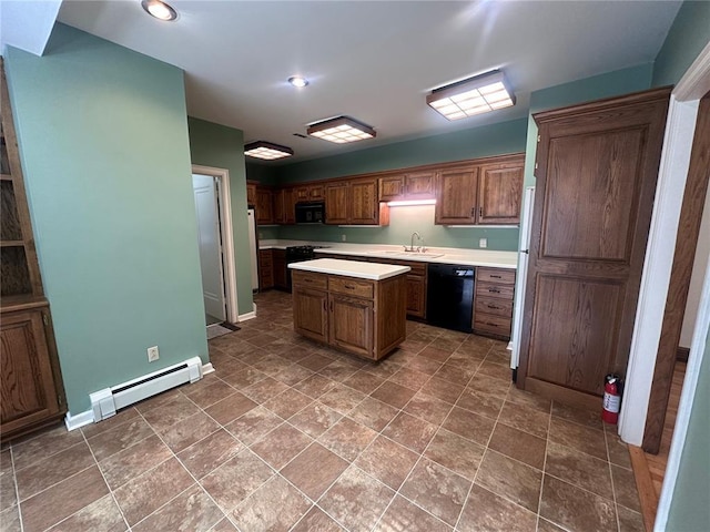 417 S Kingshighway St, Sikeston, MO 63801 - kitchen featuring black appliances, a baseboard heating unit, light countertops, a sink, and a center island