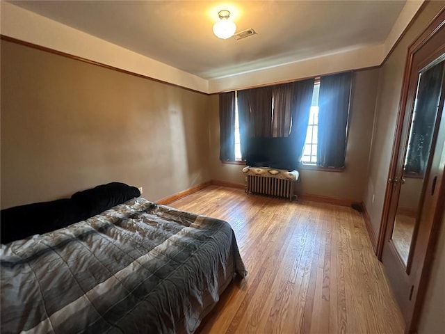 417 S Kingshighway St, Sikeston, MO 63801 - bedroom featuring radiator heating unit, light wood-style floors, and baseboards