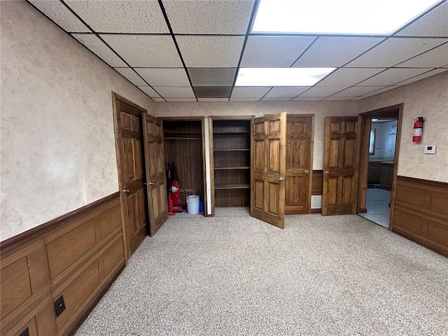 417 S Kingshighway St, Sikeston, MO 63801 - unfurnished bedroom featuring a paneled ceiling, wainscoting, and light colored carpet