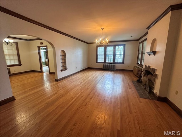 417 S Kingshighway St, Sikeston, MO 63801 - unfurnished living room with radiator, crown molding, a chandelier, and wood finished floors