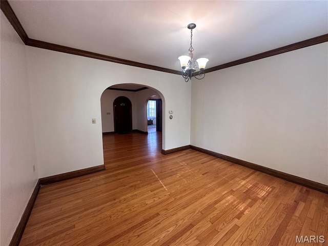 417 S Kingshighway St, Sikeston, MO 63801 - spare room with a chandelier, arched walkways, light wood finished floors, and ornamental molding