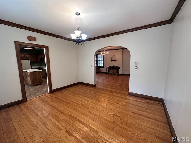 417 S Kingshighway St, Sikeston, MO 63801 - unfurnished room with arched walkways, a chandelier, crown molding, and light wood-style flooring