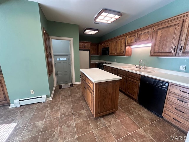 417 S Kingshighway St, Sikeston, MO 63801 - kitchen with black appliances, a baseboard heating unit, a center island, and light countertops