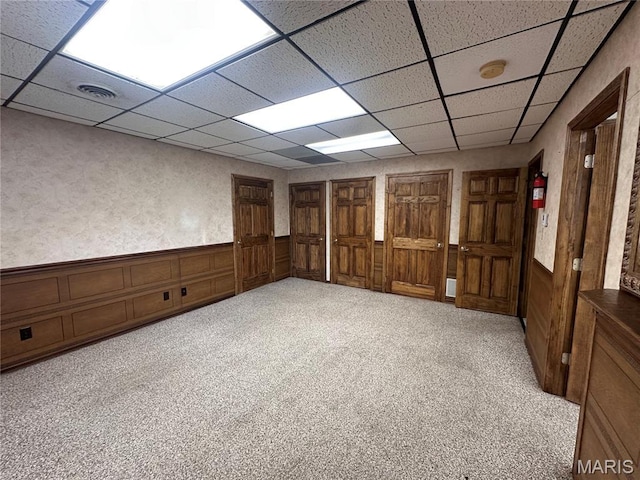 417 S Kingshighway St, Sikeston, MO 63801 - spare room featuring a drop ceiling, a smoke detector, a wainscoted wall, and carpet floors