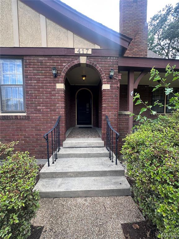 417 S Kingshighway St, Sikeston, MO 63801 - doorway to property with brick siding and a chimney